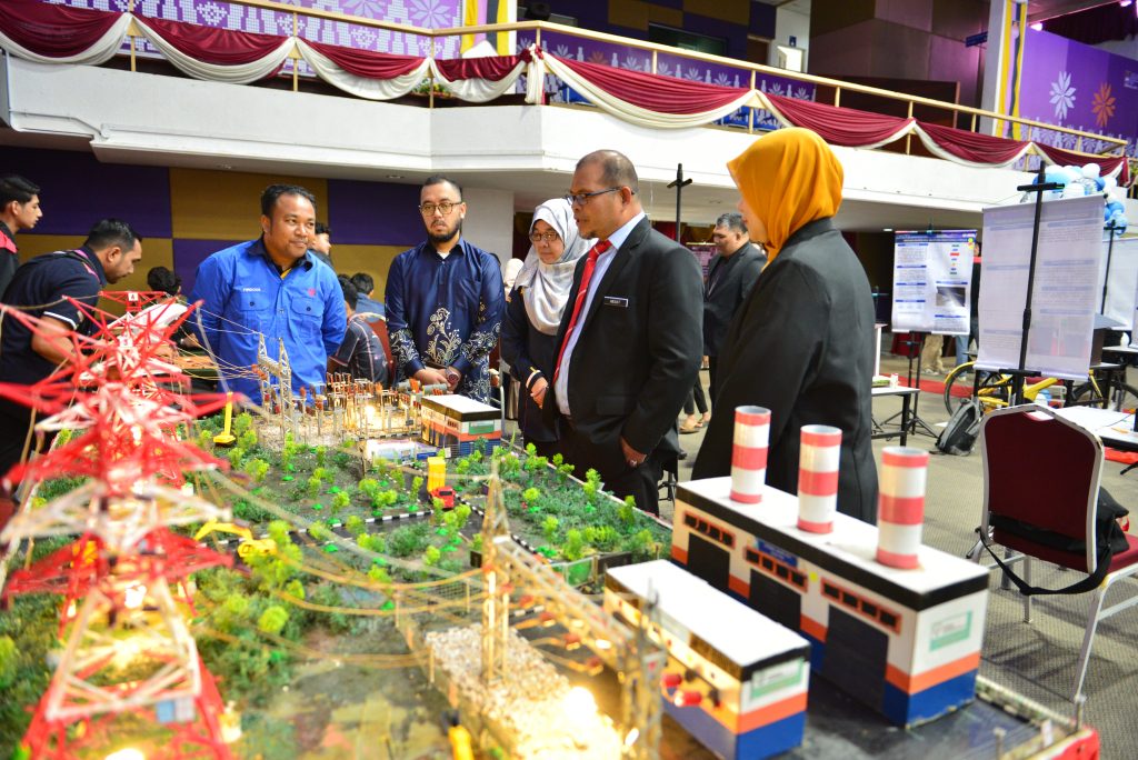 a group of people looking at a model of a city