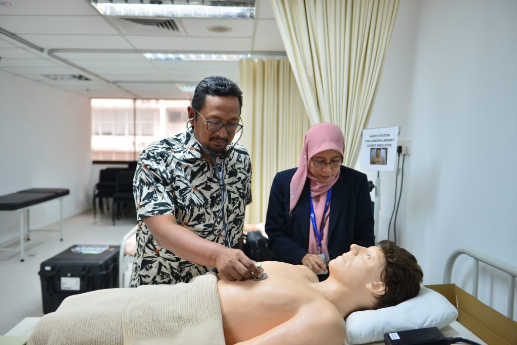 a man and woman standing next to a mannequin